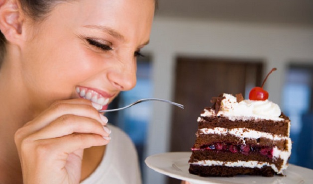 Smiling woman eating cake