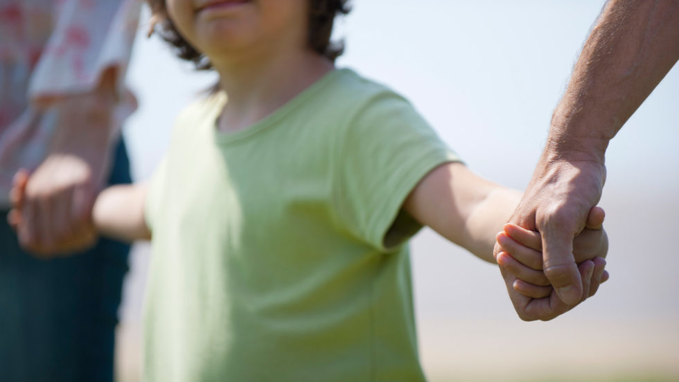 parents-holding-childs-hands