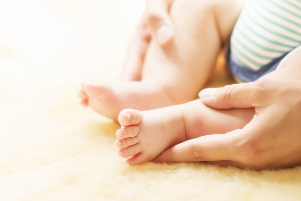 Mother holding baby feet