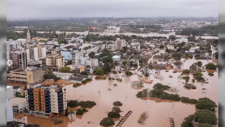 Moradores tiveram que subir até o telhado das casas para serem resgatados. (Foto: Agência Brasil)